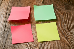 a group of colorful post-it notes on a wood surface