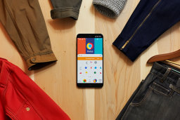 Smartphone Displaying Colorful App among Clothing