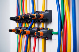 several colorful wires on a wall
