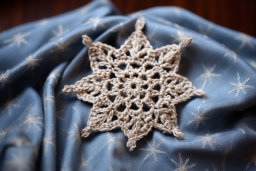 Handmade Crochet Snowflake on Fabric