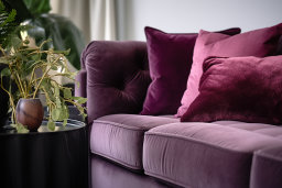 a purple couch with pillows
