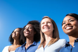 a group of women smiling and looking up