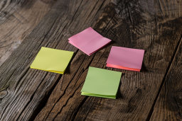 Assorted Sticky Notes on Wooden Surface