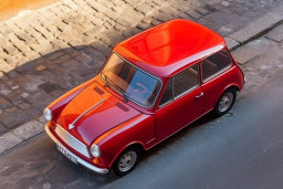 Classic Red Mini Cooper Parked on Cobblestone Street