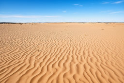 Rippled Sand Dunes Under Blue Sky