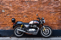 a motorcycle parked against a brick wall