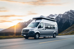 Camper Van on Mountain Road at Sunset